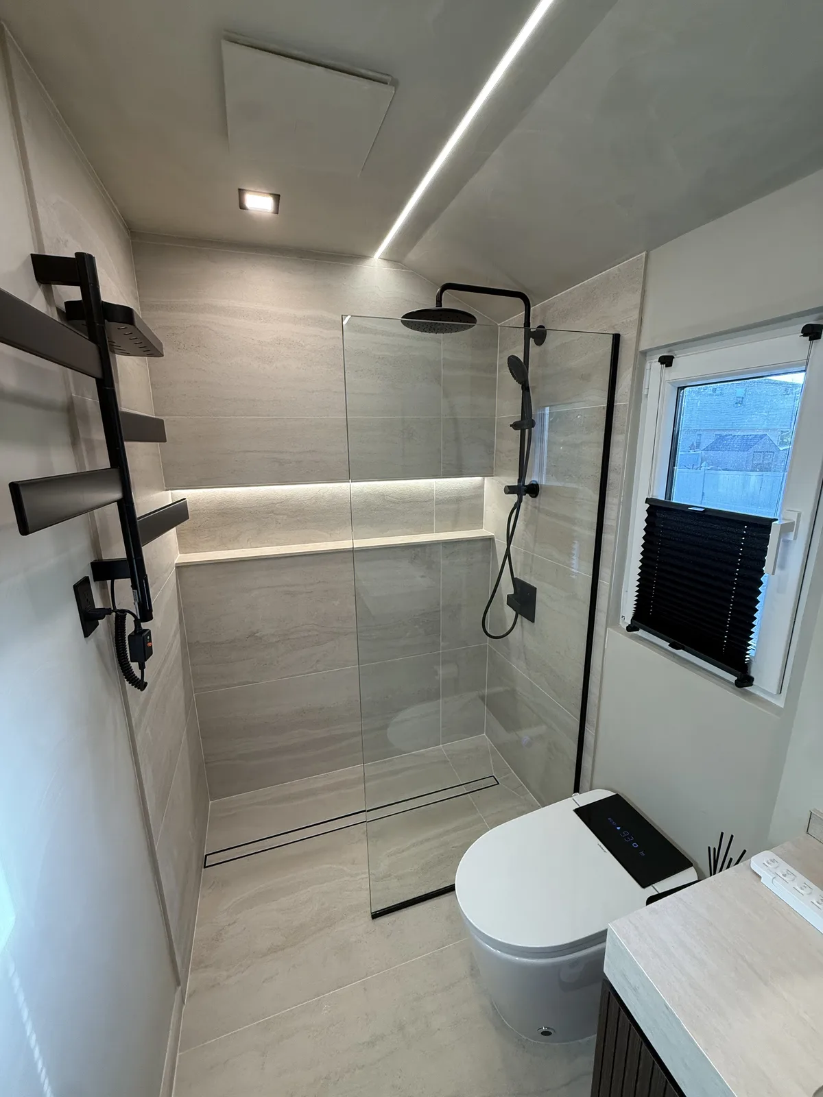 Bathroom remodel with walk-in shower and matte black fixtures in New York City