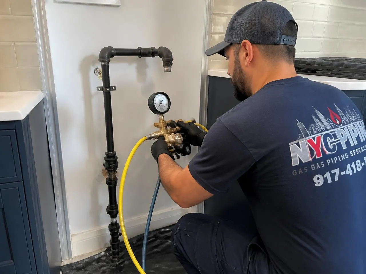 Pressure testing a gas line for a kitchen range in an NYC apartment by a licensed plumbing contractor
