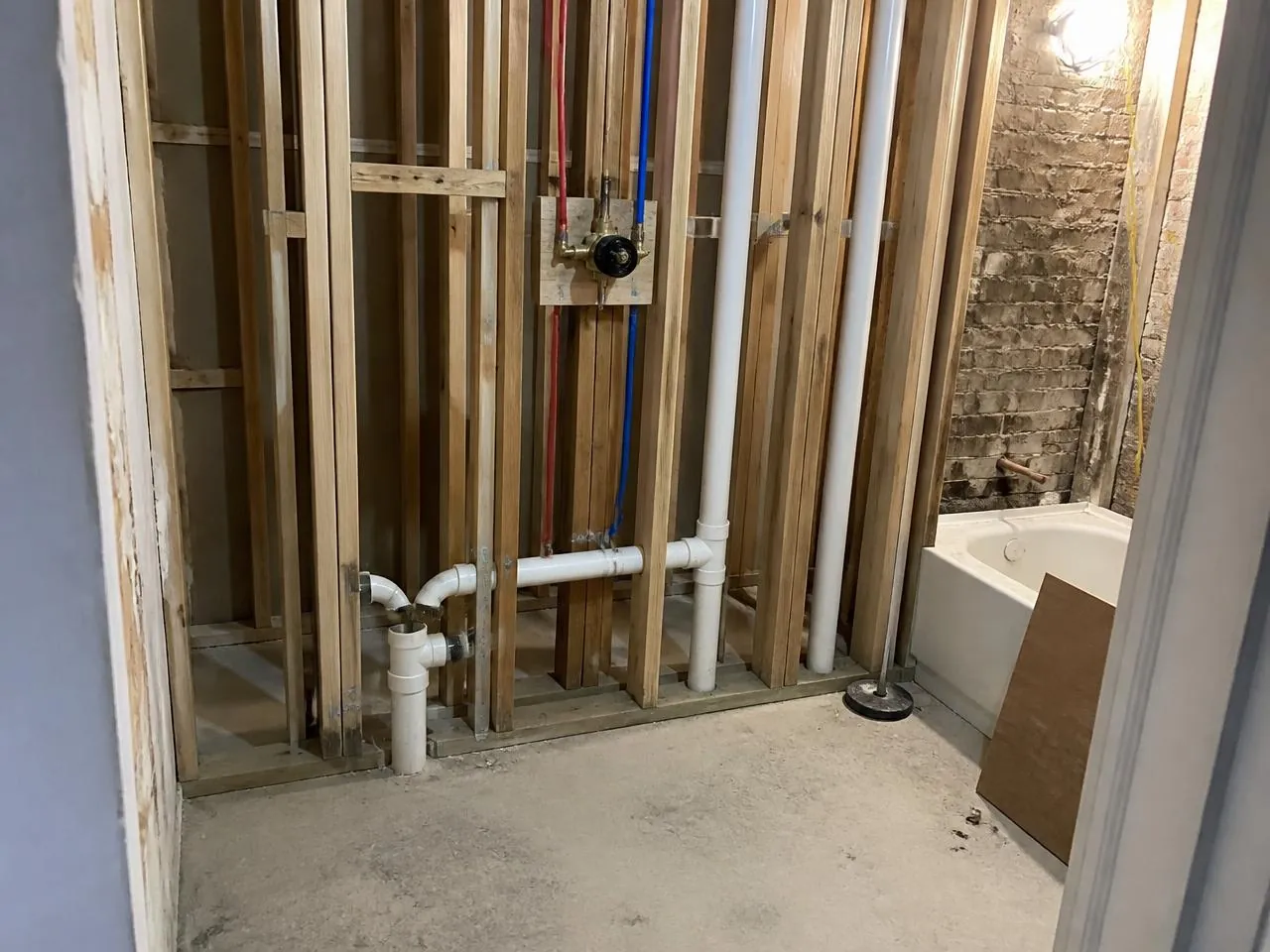 Bathroom plumbing rough-in during an NYC apartment renovation — plumbing services NYC by Melani General Contractor
