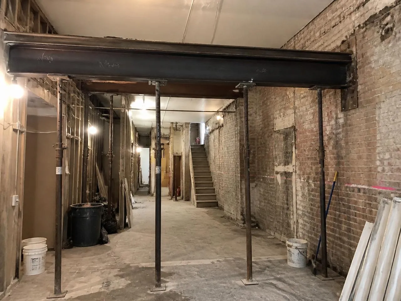 Structural work during a townhouse renovation NYC with new steel beam and temporary shoring posts