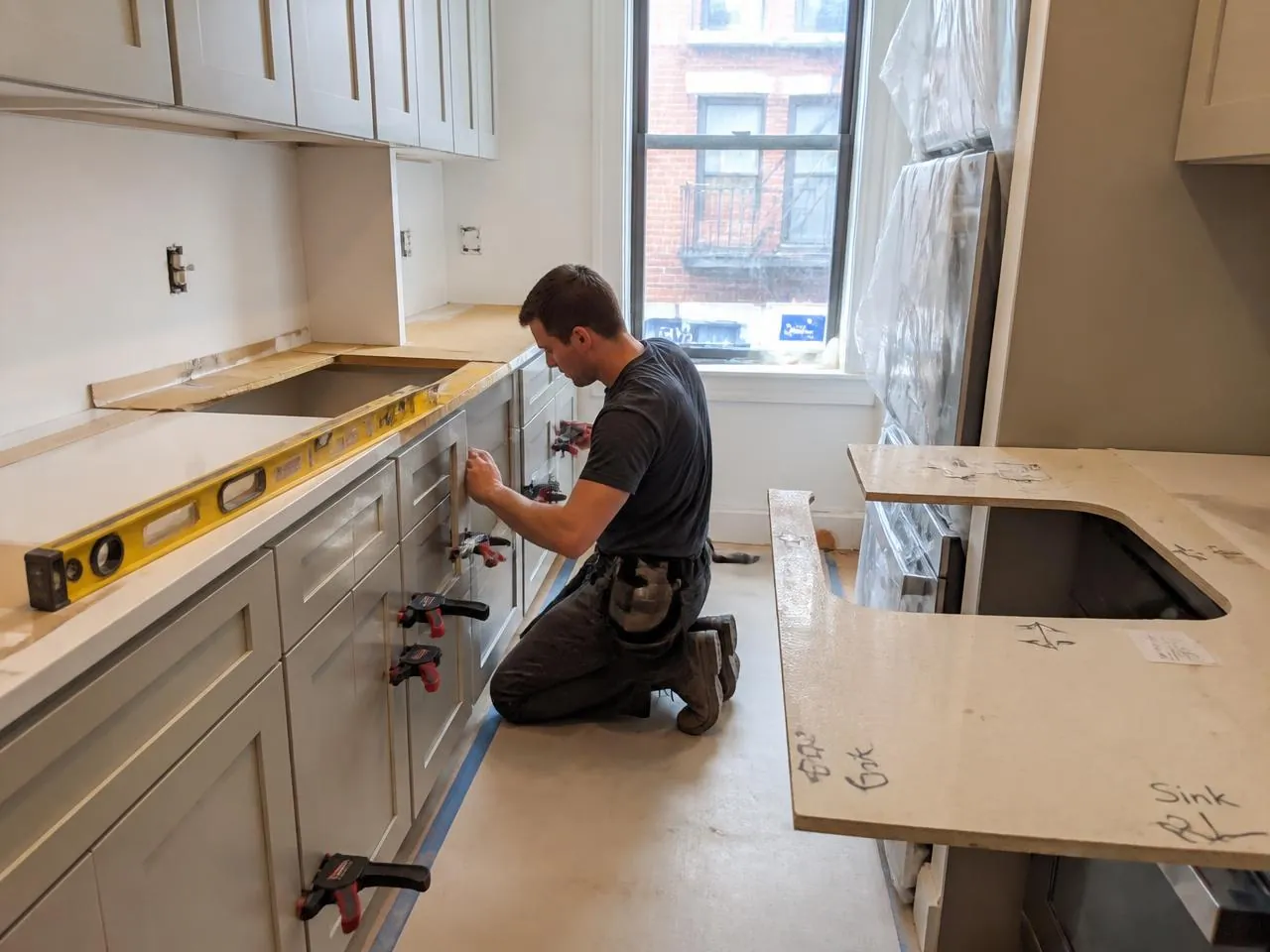 Custom cabinet installation during a kitchen renovation NYC with countertop templating