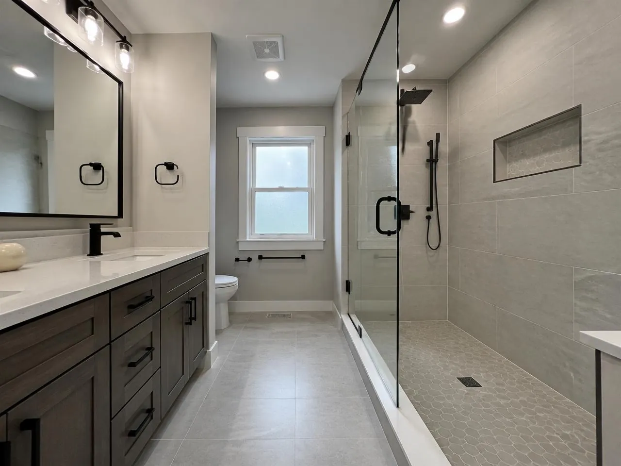 Staten Island bathroom renovation by Melani General Contractor with walk-in glass shower and double vanity