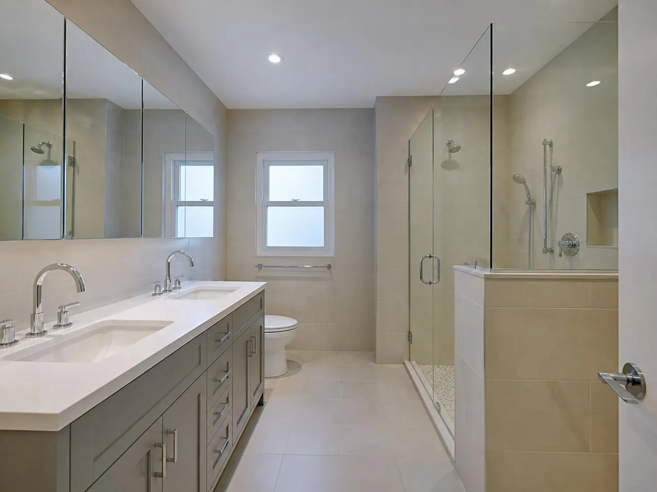 Queens bathroom renovation by Melani General Contractor with walk-in glass shower and double vanity