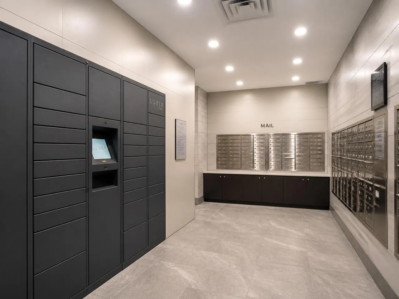 Renovated residential package and mail room in a New York City building with secure parcel lockers and LED lighting