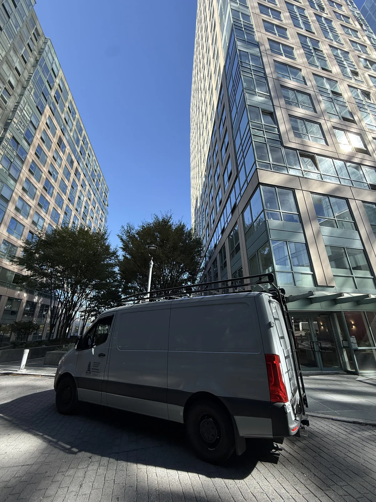 Melani Contracting work van at a Manhattan high-rise renovation project