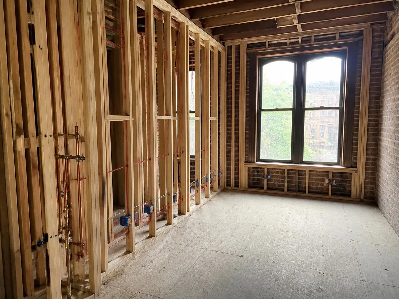 Gut renovation in progress in a Park Slope brownstone with new copper plumbing and electrical rough-in
