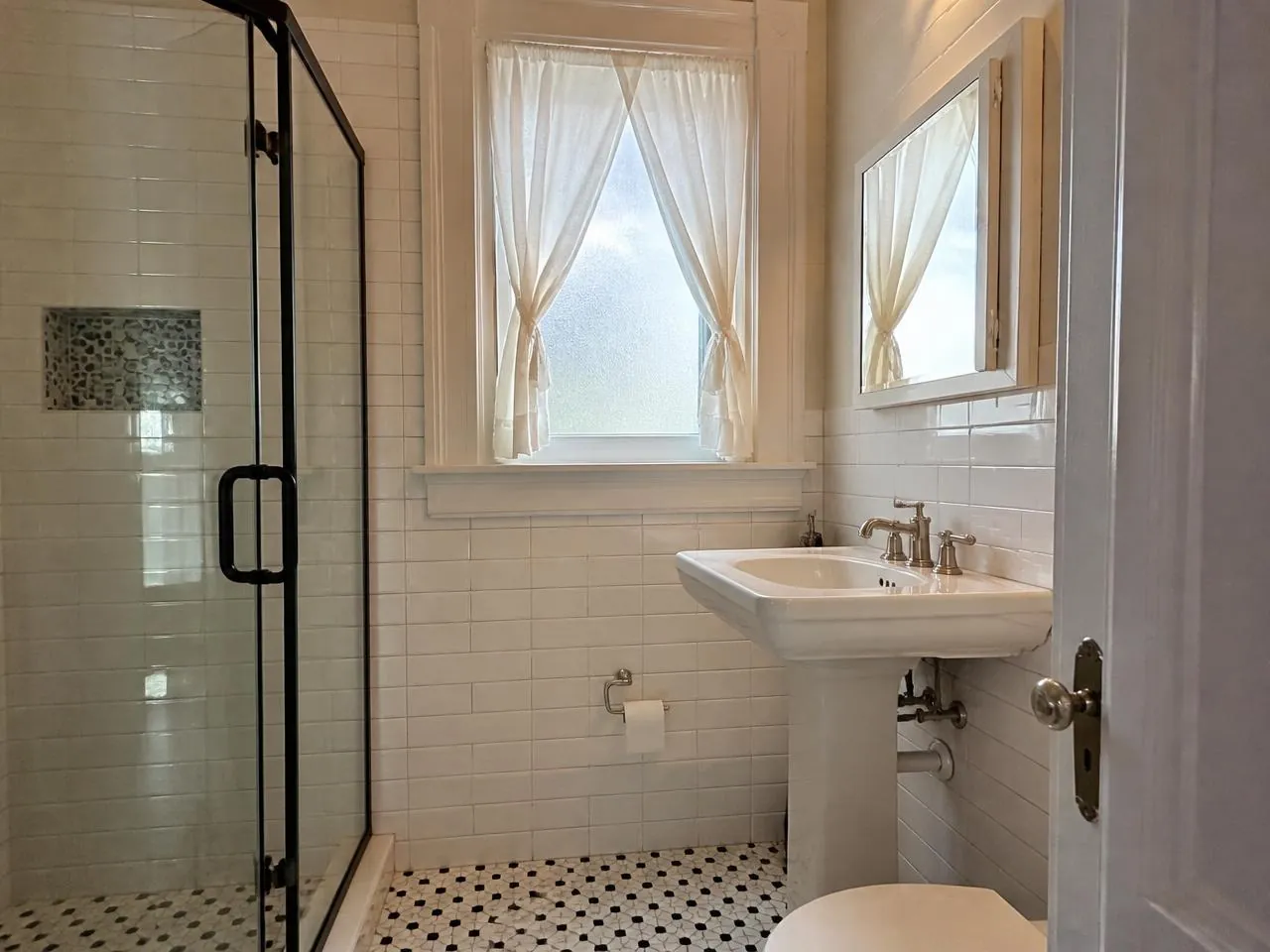 Park Slope bathroom renovation with white subway tile and walk-in glass shower by Melani General Contractor