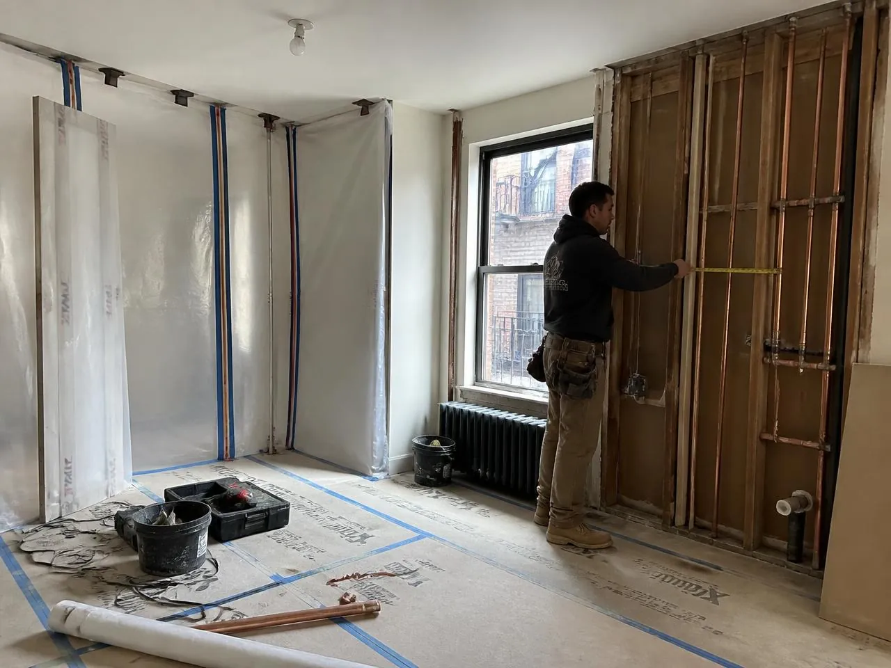 Brooklyn apartment renovation by Melani General Contractor with floor protection and new copper plumbing rough-in