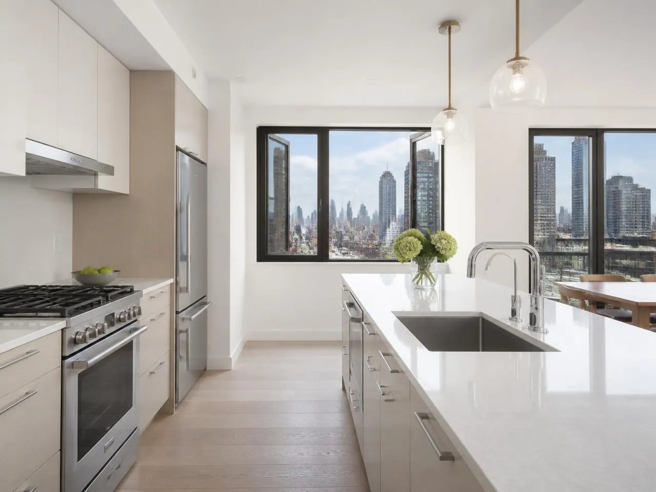 Renovated post-war NYC co-op kitchen with quartz counters and city skyline view