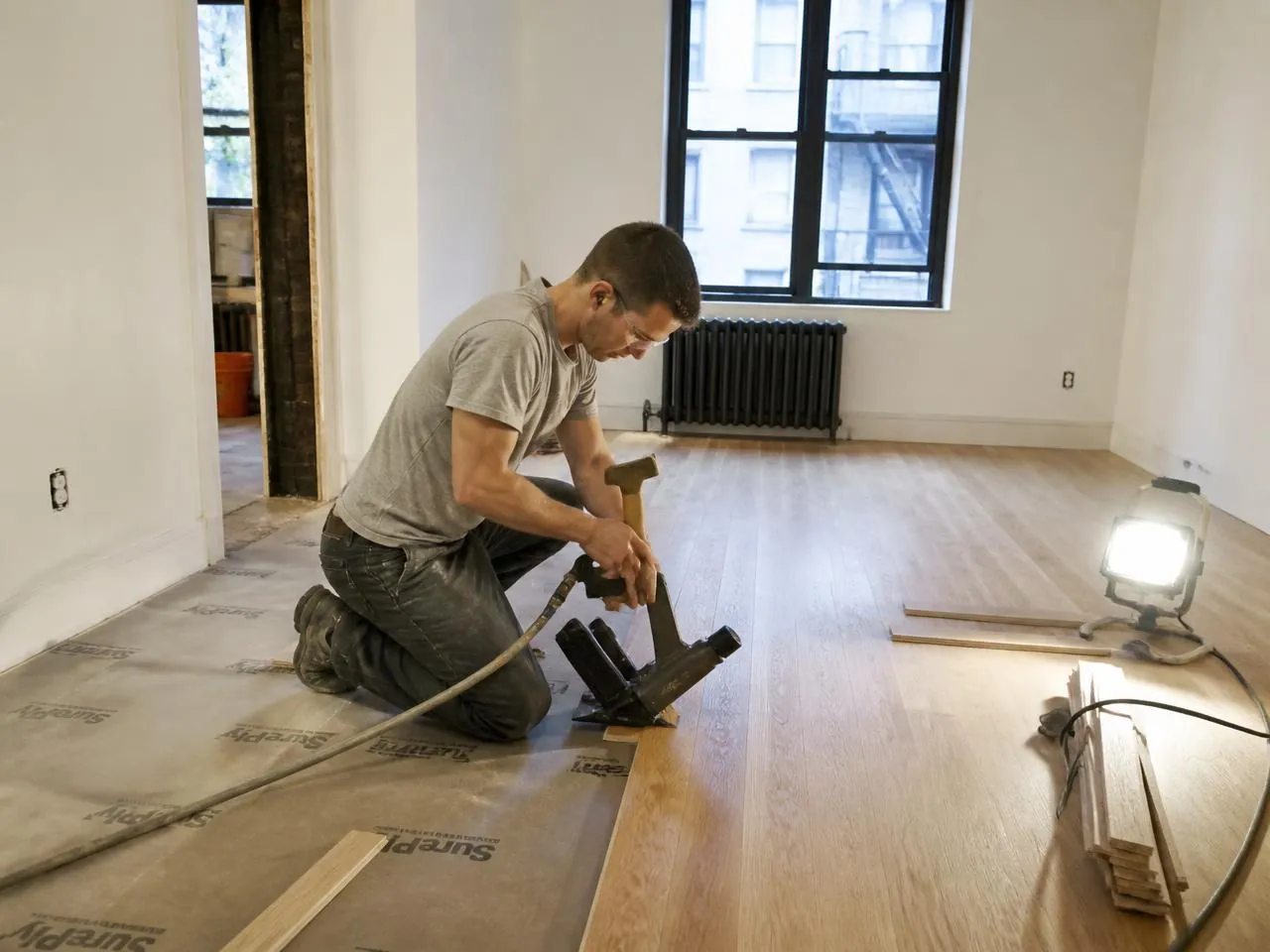 Hardwood floor installation NYC — nail-down white oak planks in a renovated apartment