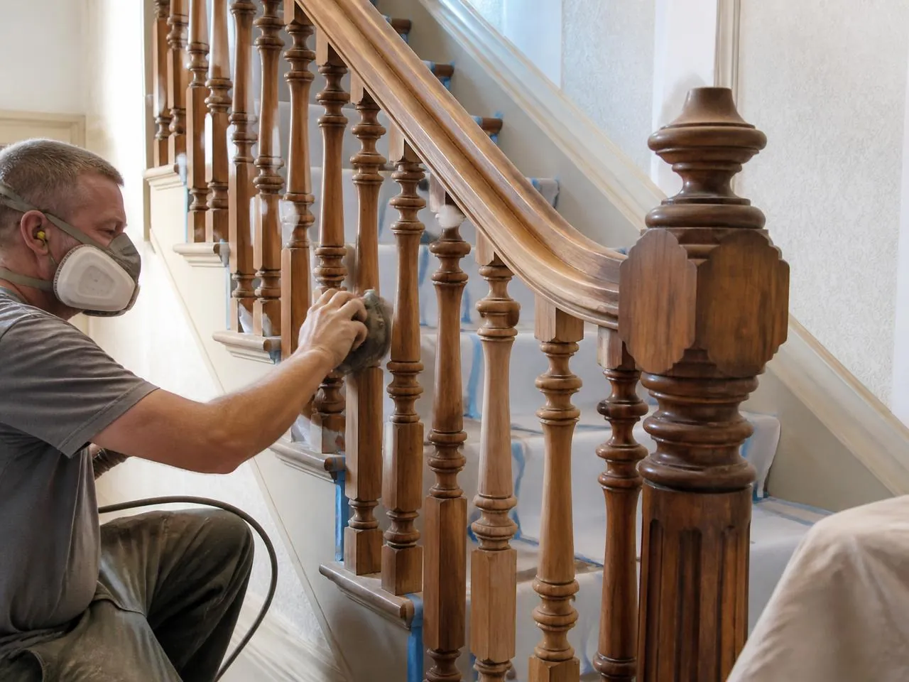 Original staircase restoration during a NYC townhouse renovation with refinished balusters and handrail