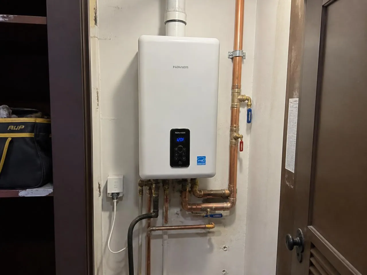 Tankless water heater installation with copper piping in a Brooklyn brownstone — plumbing services NYC