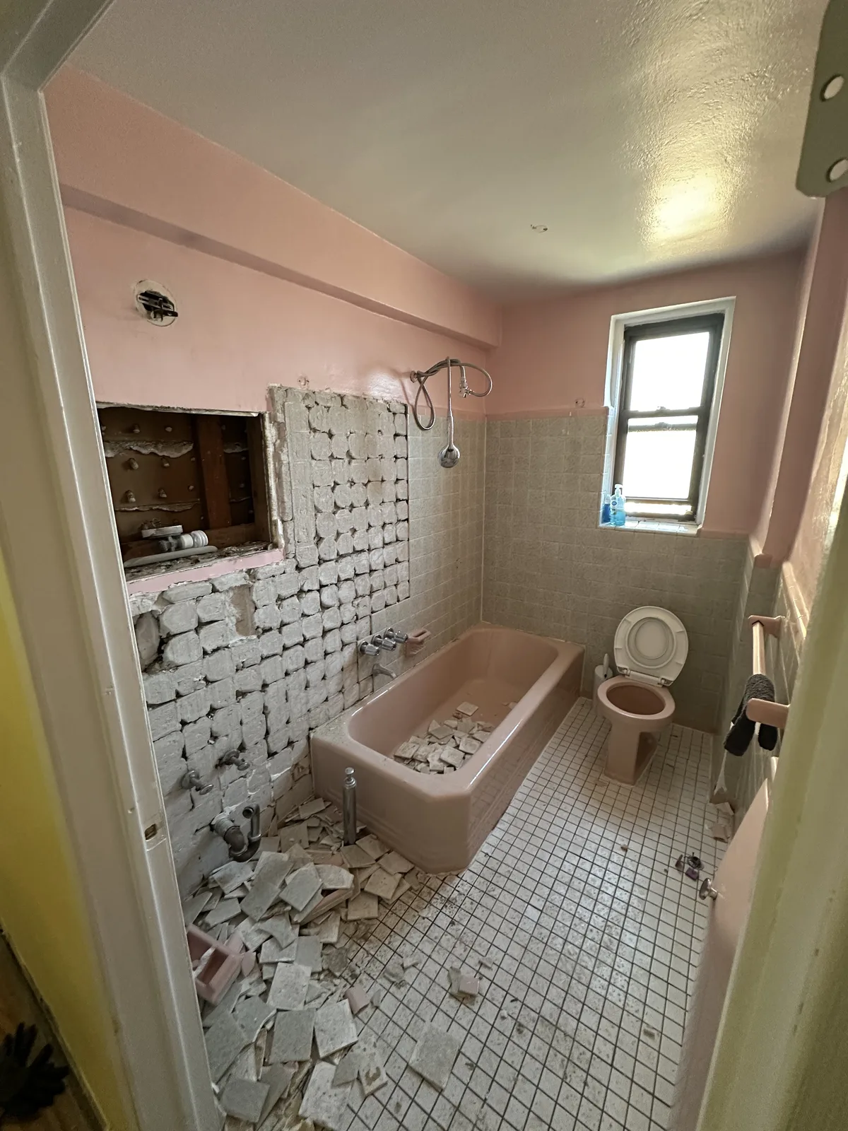 Bathroom demolition before photo with original pink tile in New York City