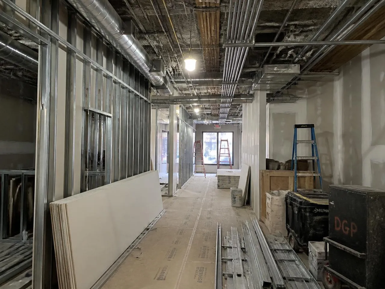 Commercial renovation NYC retail buildout with new metal stud framing, conduit and ductwork in progress