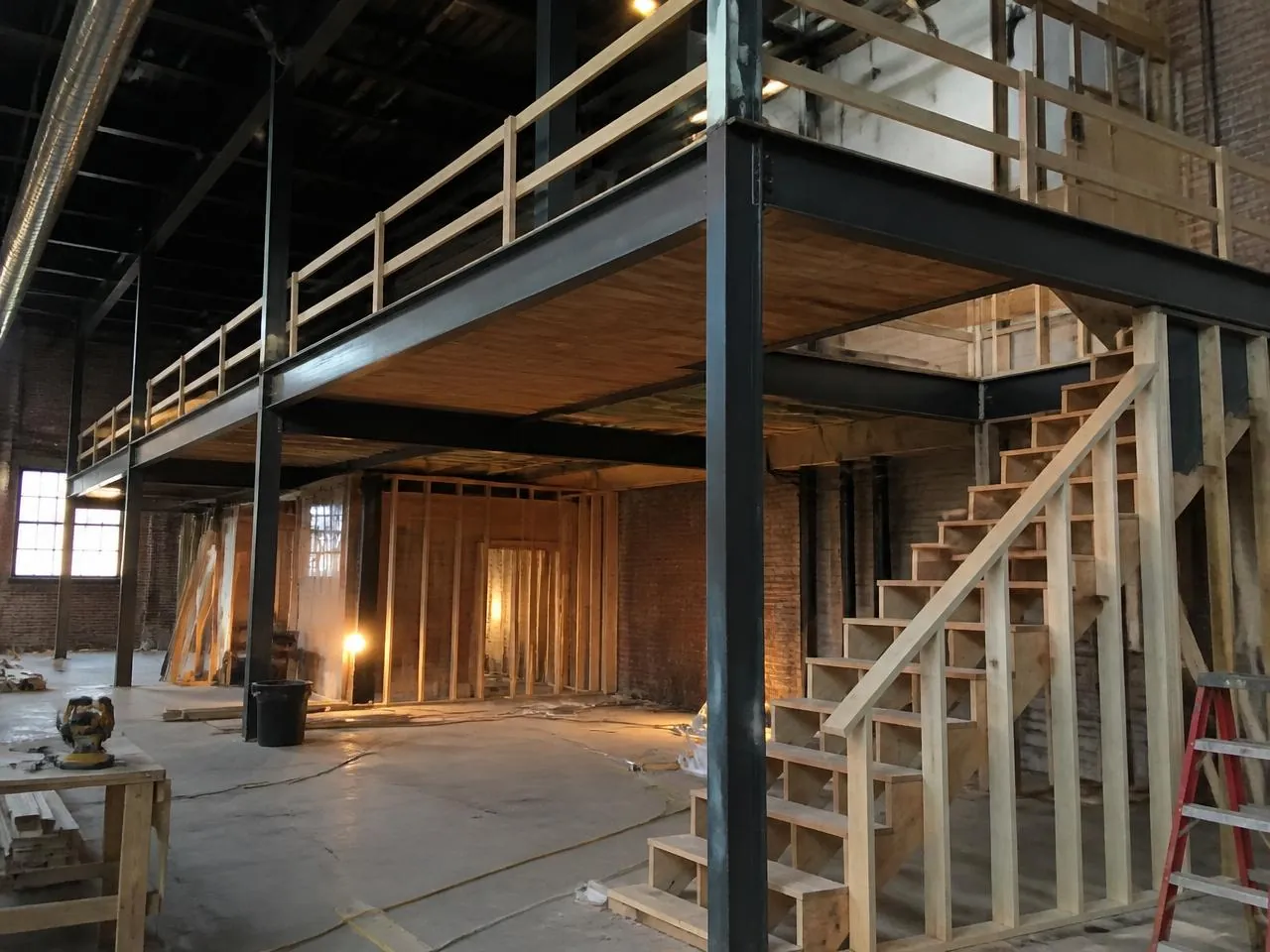 Loft renovation NYC mezzanine construction with structural steel framing and code-compliant stair