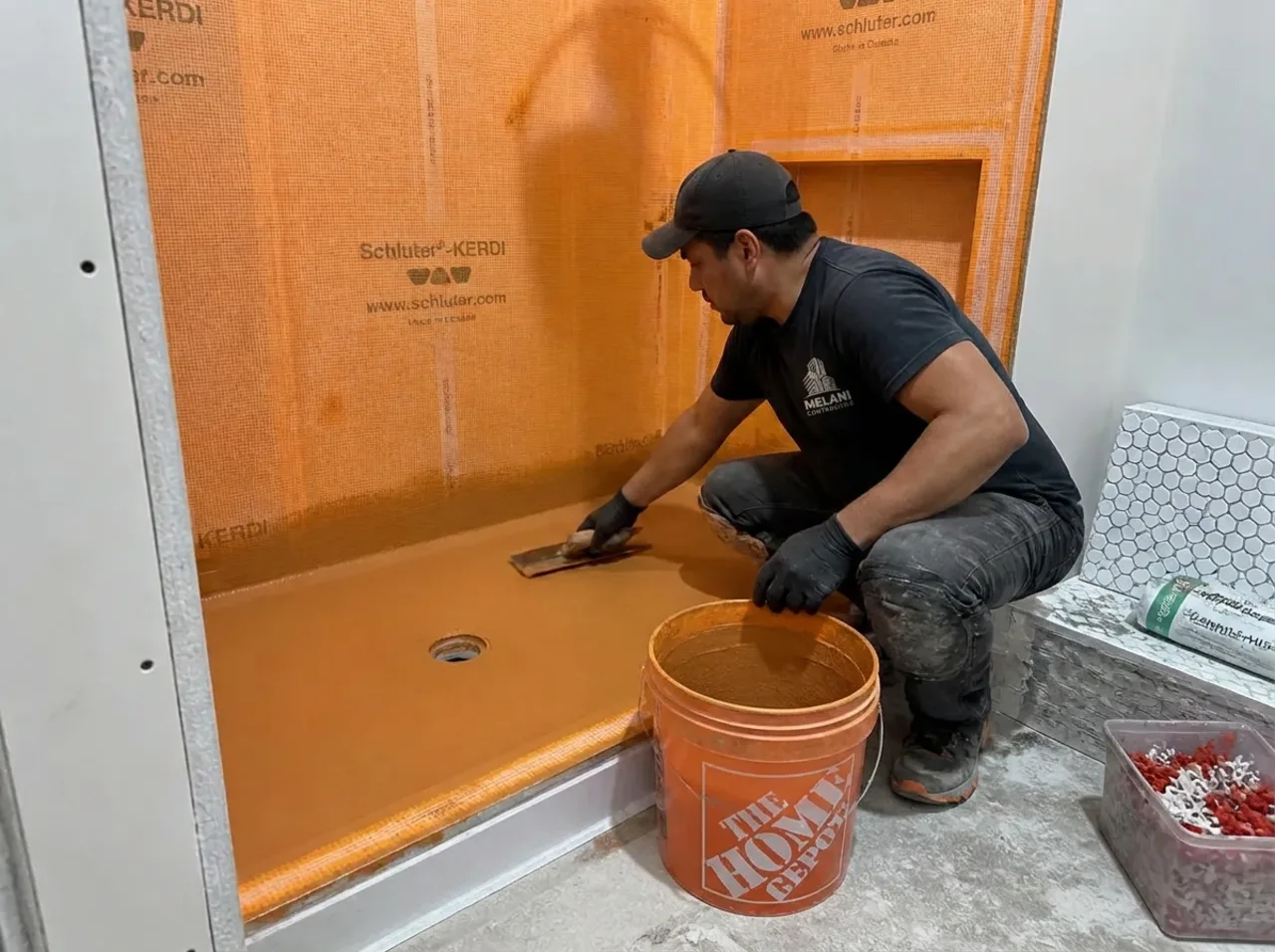 Rubber waterproofing membrane applied to a shower pan during a bathroom renovation in New York City