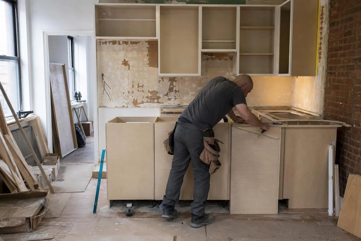 Kitchen renovation work progressing from demolition through cabinet and finish installation